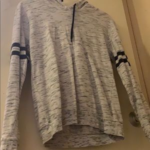 Grey hoodie with black strips around the elbow